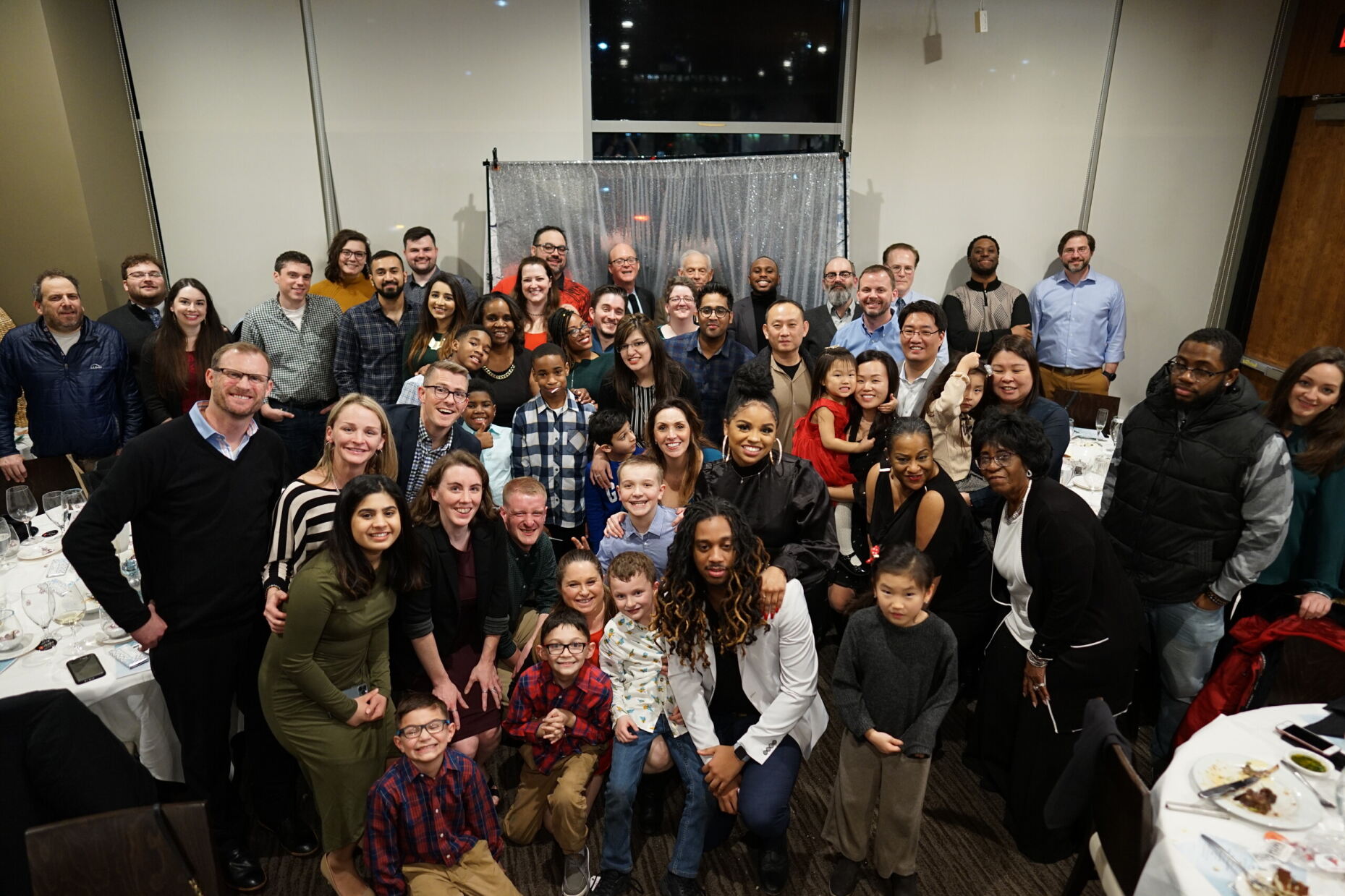 Picture of FedWriters leadership, employees, and family celebrating together at a holiday party.