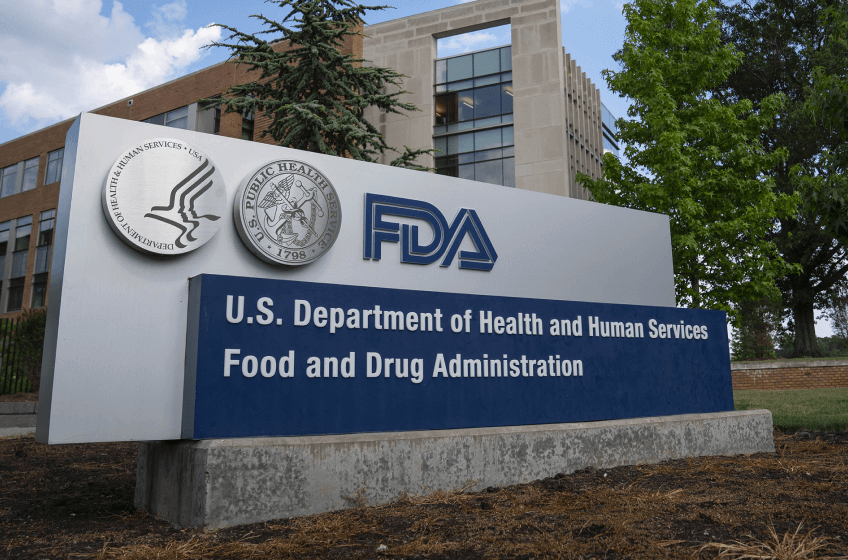 Sign outside a building with multiple logos: US Department of Health and Human Services Food and Drug Administration.